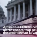 Cigarette électronique devant des dossiers évoquant l’alerte visant Altria et la FDA